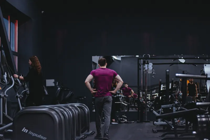 Man in a gym with fitness equipment, highlighting a healthy lifestyle